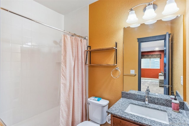 bathroom featuring vanity, toilet, and a shower with curtain