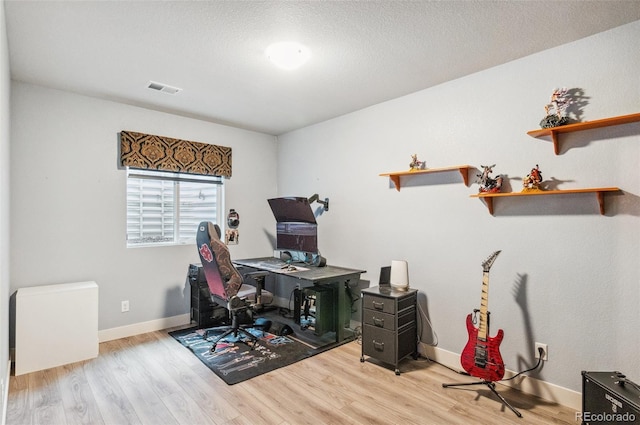 office space featuring light hardwood / wood-style floors and a textured ceiling