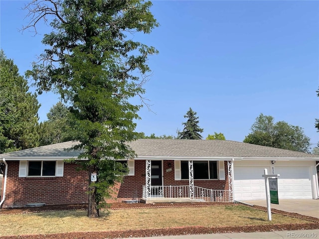 single story home with covered porch and a garage