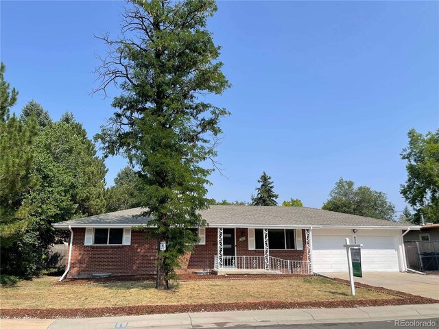 single story home featuring a garage and covered porch