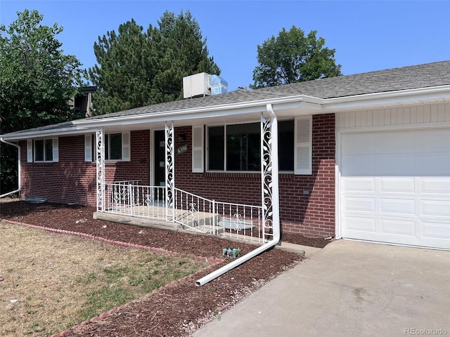 ranch-style house featuring a garage and a porch