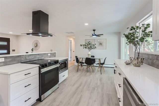 kitchen featuring white cabinetry, backsplash, light hardwood / wood-style floors, appliances with stainless steel finishes, and island range hood