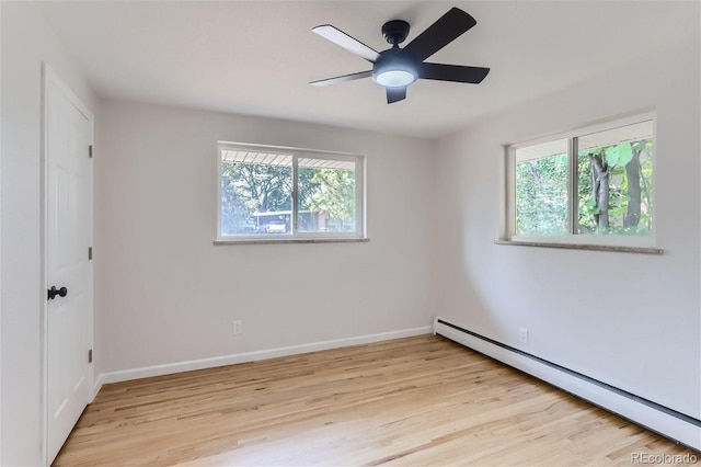 unfurnished room featuring ceiling fan, light hardwood / wood-style floors, a baseboard radiator, and plenty of natural light