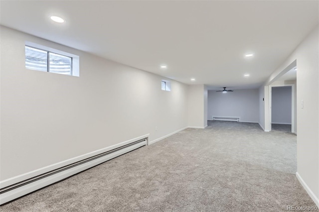 basement featuring a baseboard heating unit and carpet flooring