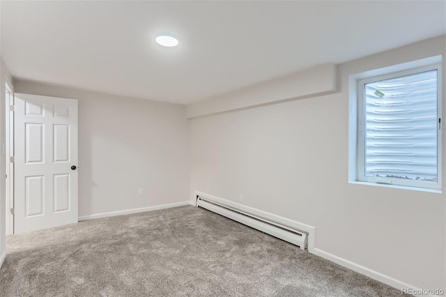 empty room featuring carpet, baseboard heating, and a healthy amount of sunlight