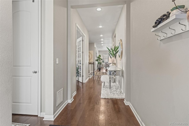 hallway with dark hardwood / wood-style flooring