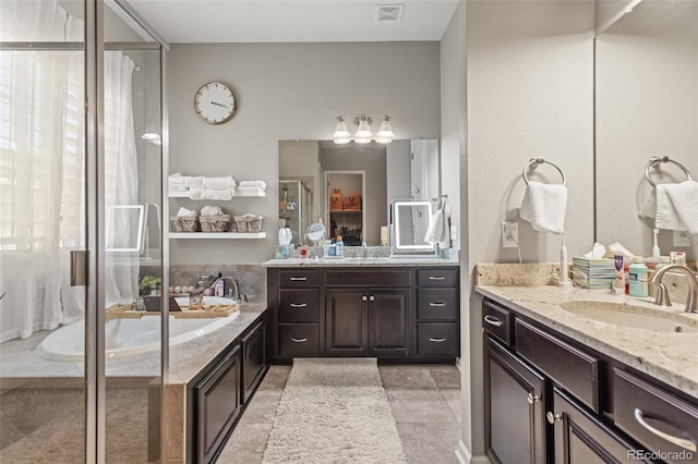 bathroom featuring shower with separate bathtub and vanity