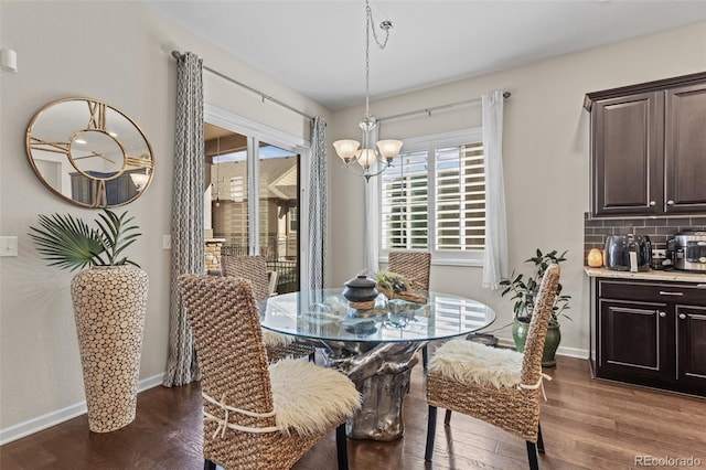 dining space with a chandelier and dark hardwood / wood-style floors