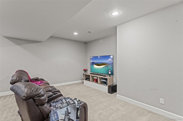 living room featuring light carpet and a textured ceiling