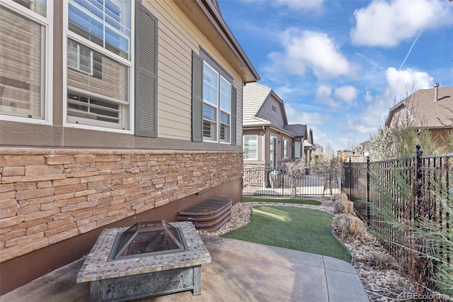 exterior space featuring a patio area and an outdoor fire pit