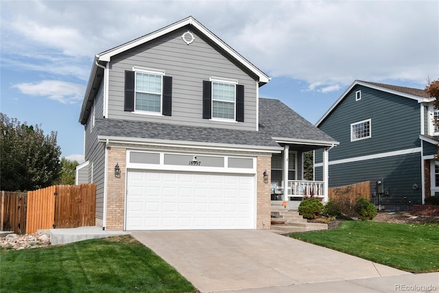 view of front property featuring a garage, a porch, and a front lawn