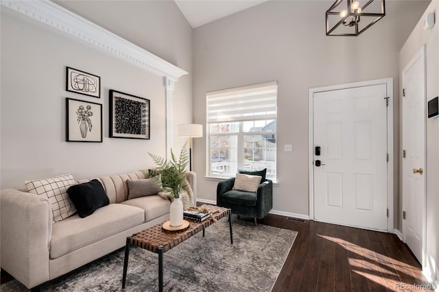 living room featuring dark hardwood / wood-style flooring and a chandelier