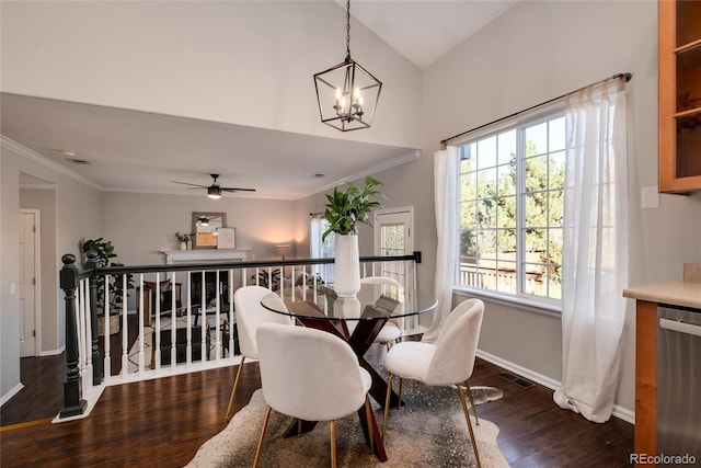 dining space with ceiling fan with notable chandelier, a wealth of natural light, and dark hardwood / wood-style floors