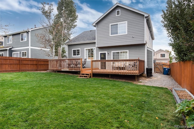 rear view of house featuring central AC, a yard, and a wooden deck