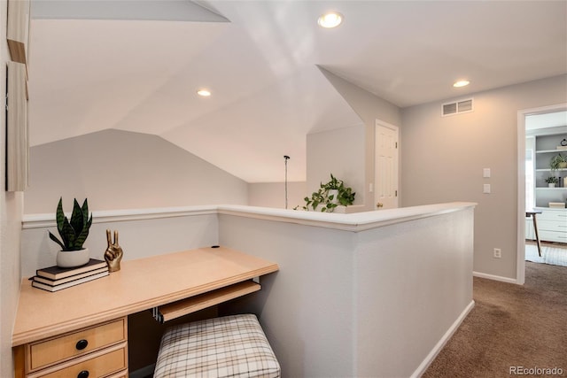 office with lofted ceiling and carpet flooring