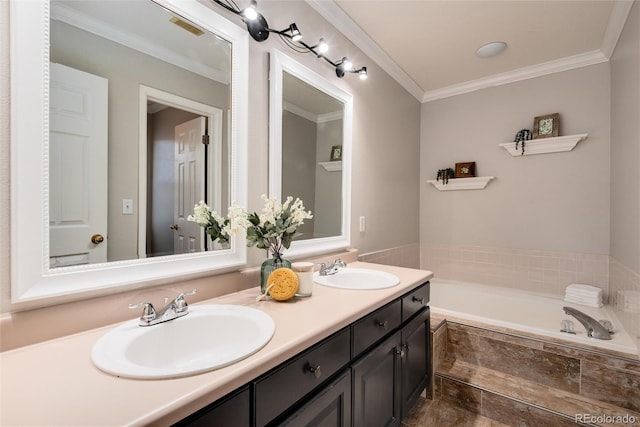 bathroom with crown molding, tiled tub, and vanity