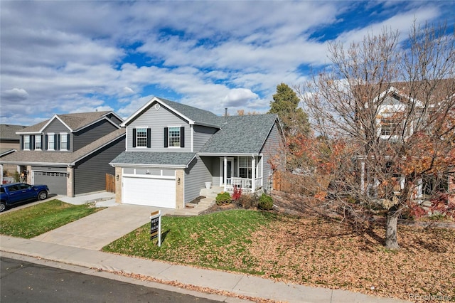 view of front of home with a garage, covered porch, and a front lawn