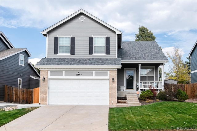 view of front property featuring a porch, a front yard, and a garage