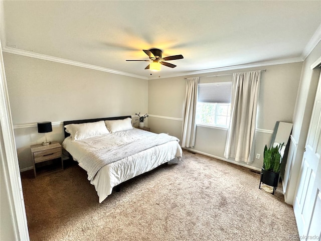 bedroom featuring crown molding, carpet floors, baseboards, and a ceiling fan