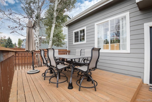 wooden terrace featuring outdoor dining area