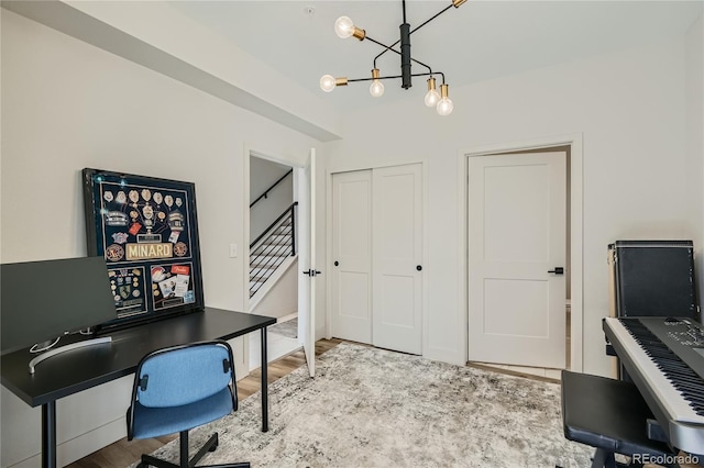 home office featuring a chandelier and hardwood / wood-style flooring