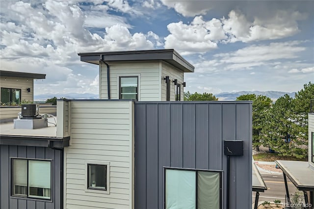 view of home's exterior featuring a mountain view and cooling unit