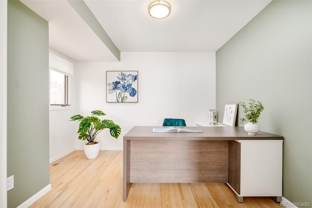 office area featuring light wood-style floors, visible vents, and baseboards