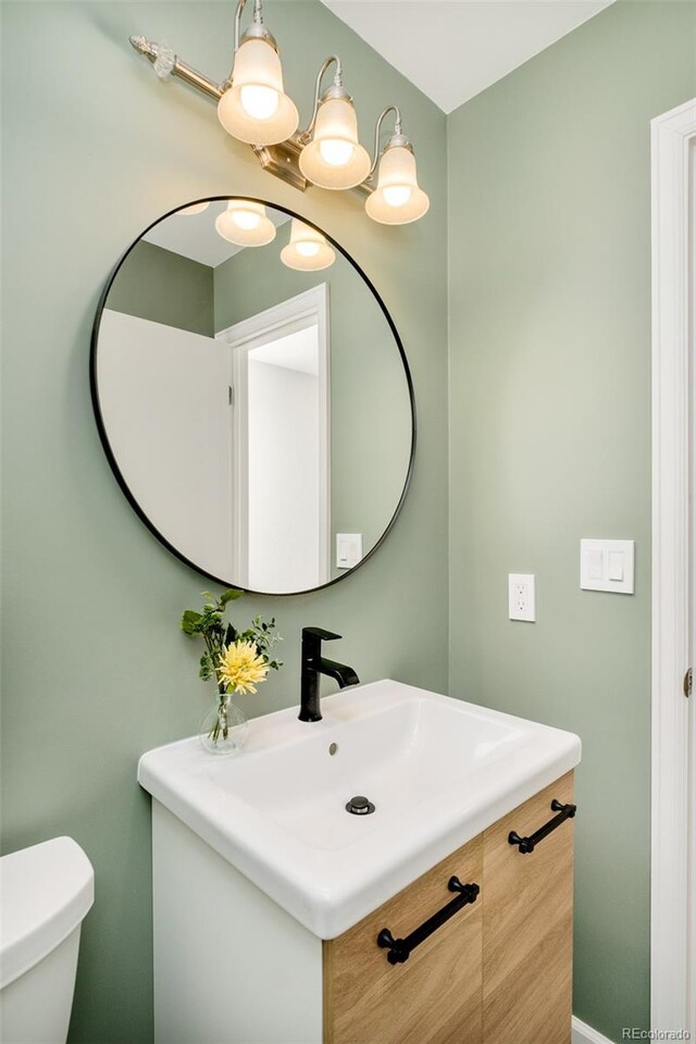 half bath with vanity and toilet