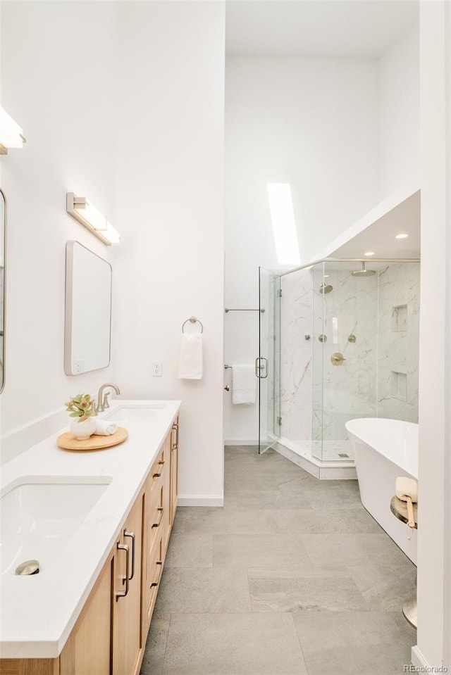 full bath featuring a freestanding tub, a sink, a shower stall, and double vanity