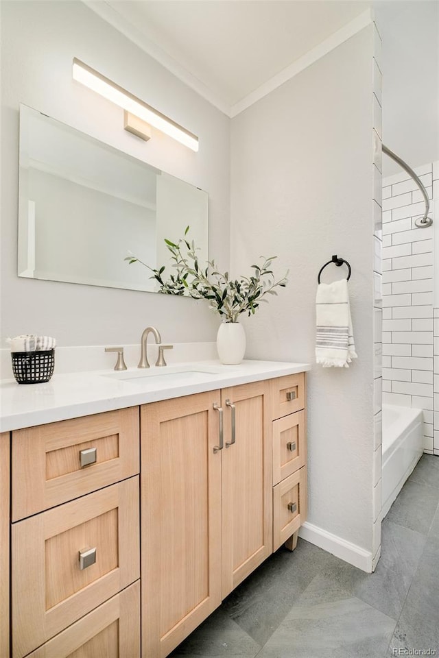 bathroom with  shower combination, crown molding, vanity, and baseboards