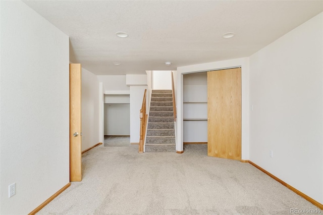 unfurnished bedroom featuring carpet floors and baseboards