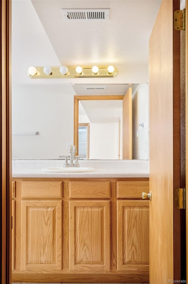 bathroom with visible vents and vanity