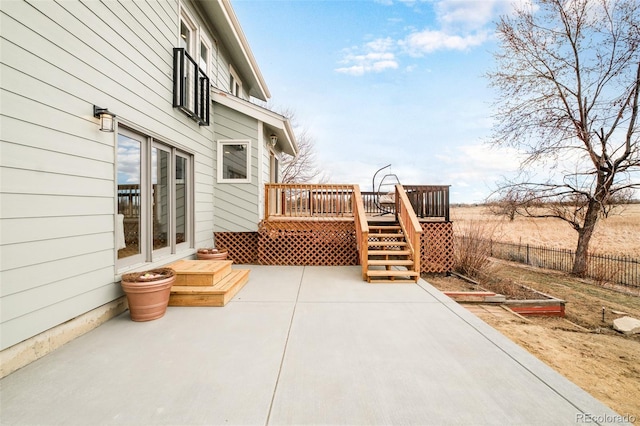 view of patio with a deck and fence