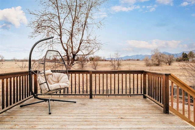 deck featuring a mountain view and a rural view