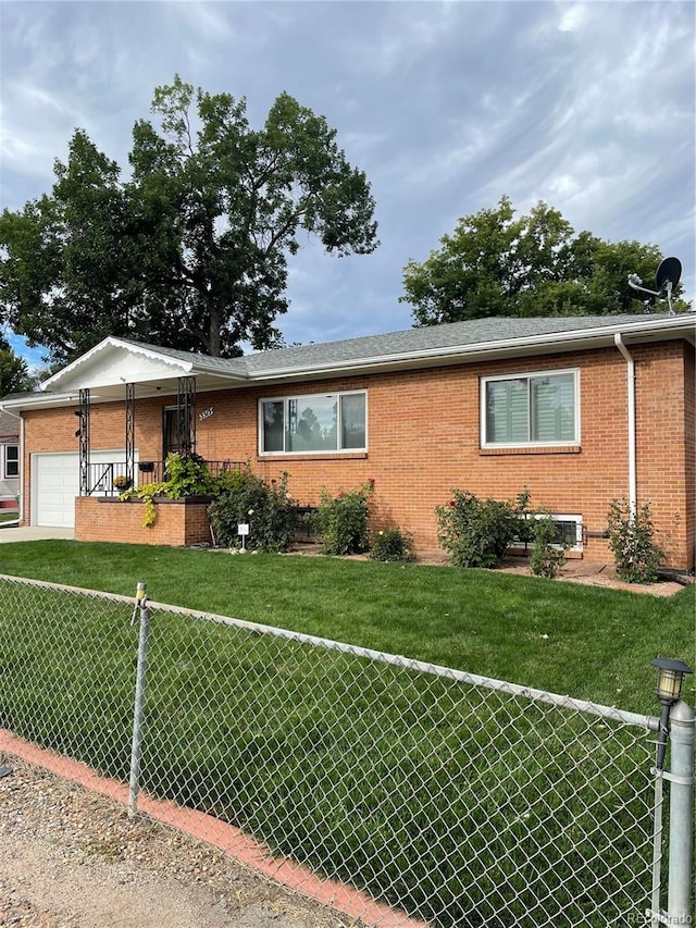 view of front of home featuring a garage and a front lawn