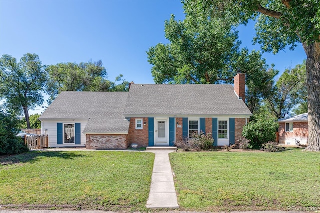 1521 Columbine Blvd, Colorado Springs, CO 80907 - view of front facade with a chimney, brick siding, and a shingled roof