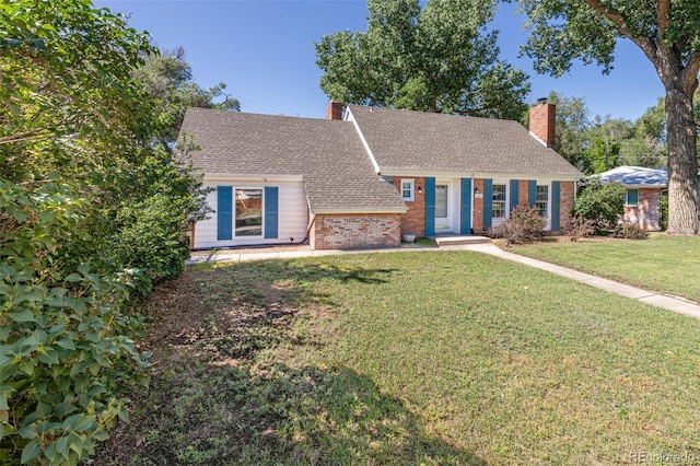 1521 Columbine Blvd, Colorado Springs, CO 80907 - view of front of property with brick siding, a front yard, roof with shingles, and a chimney