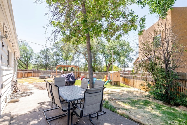 1521 Columbine Blvd, Colorado Springs, CO 80907 - fenced backyard featuring a patio area, a playground, and outdoor dining space