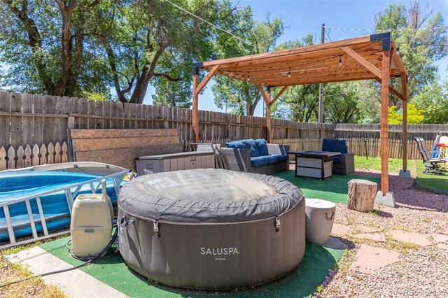 1521 Columbine Blvd, Colorado Springs, CO 80907 - fenced backyard featuring a hot tub and outdoor lounge area