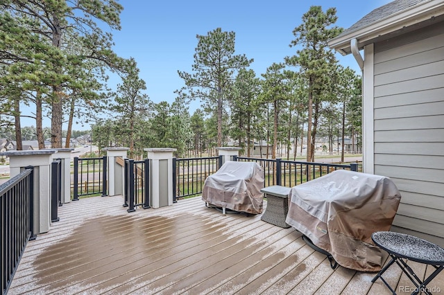 wooden deck with a grill