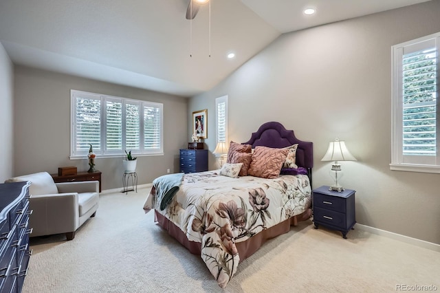 bedroom featuring vaulted ceiling, light colored carpet, and multiple windows
