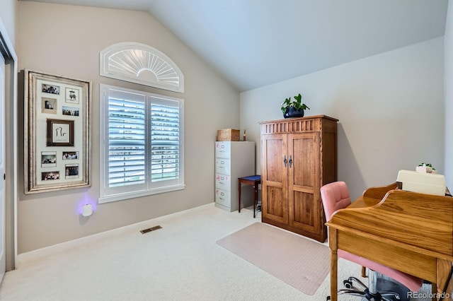 home office featuring vaulted ceiling, carpet flooring, and visible vents