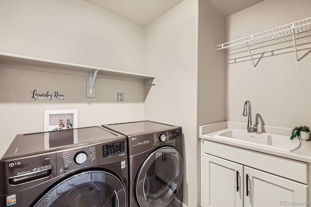 laundry area with a sink, independent washer and dryer, and cabinet space