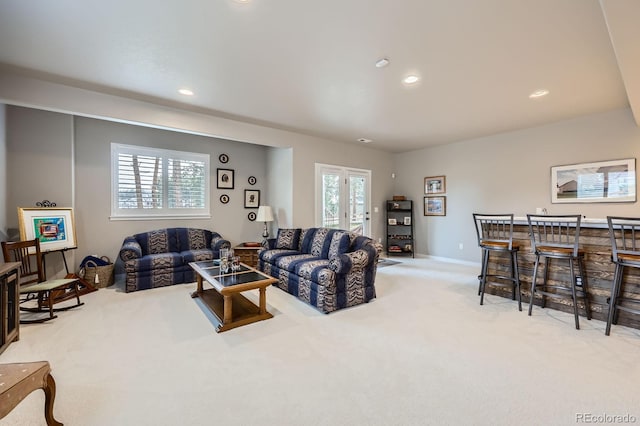 carpeted living area featuring baseboards, a dry bar, and recessed lighting