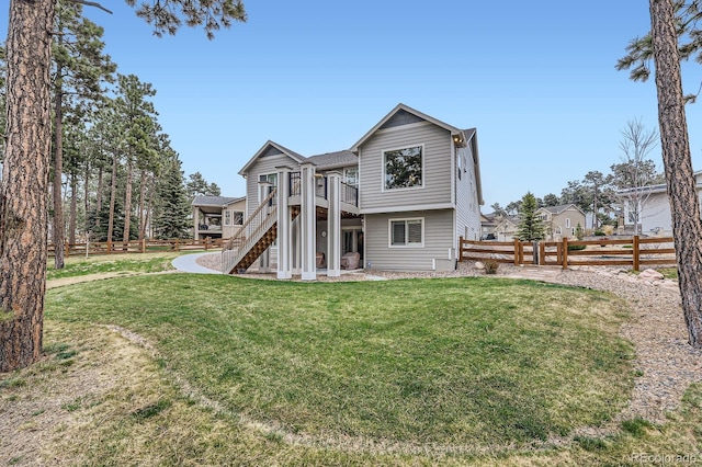 back of house featuring a fenced backyard, stairway, a deck, and a yard