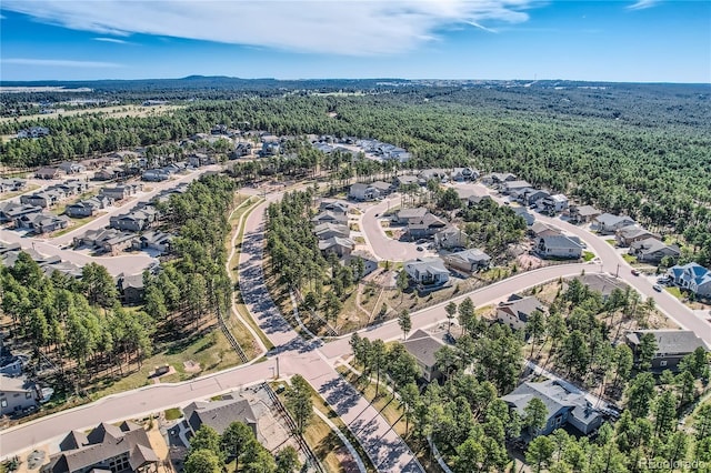 birds eye view of property featuring a residential view and a view of trees