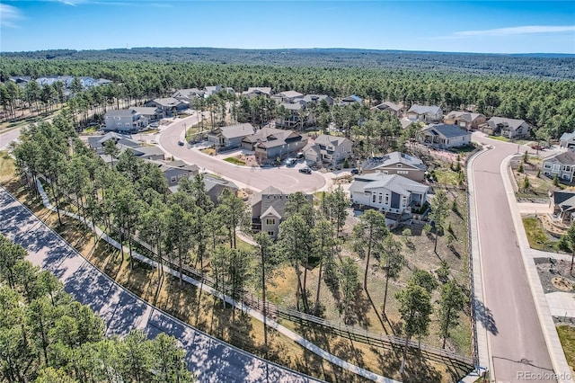 aerial view featuring a residential view and a wooded view