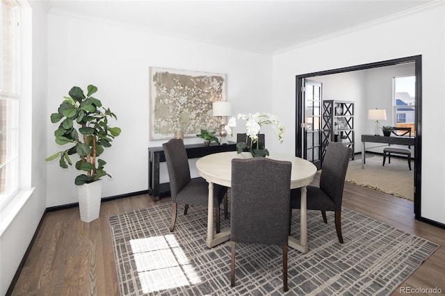 dining room featuring hardwood / wood-style flooring and ornamental molding