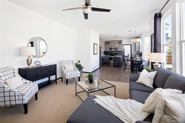 carpeted living room featuring ceiling fan