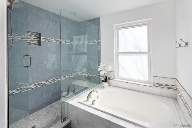 bathroom featuring plus walk in shower and a wealth of natural light